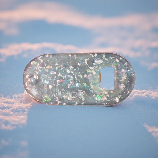 Bottle opener with glittery finish on a blue background