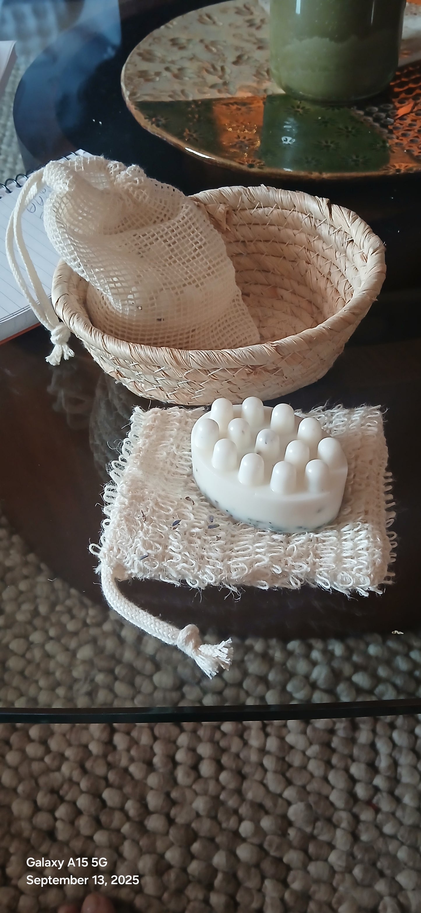 Two textured soap dishes on a textured surface