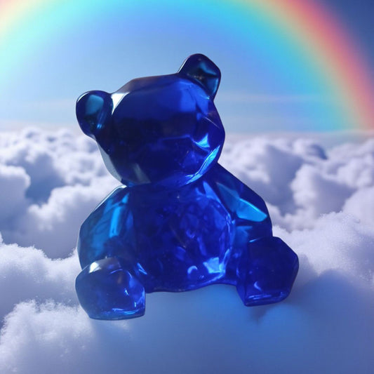 Blue teddy bear on a cloud with a rainbow in the background