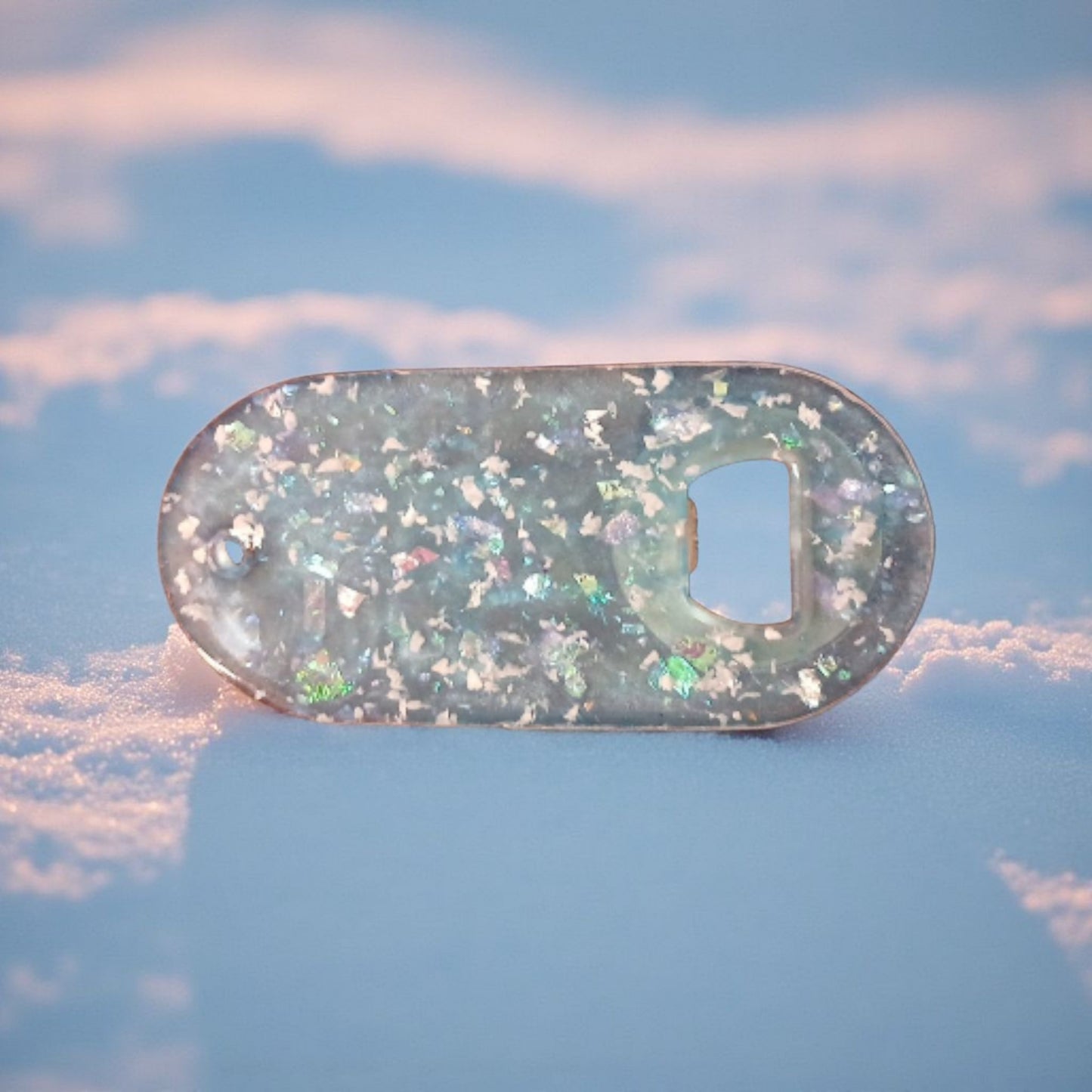 Bottle opener with glittery finish on a blue background