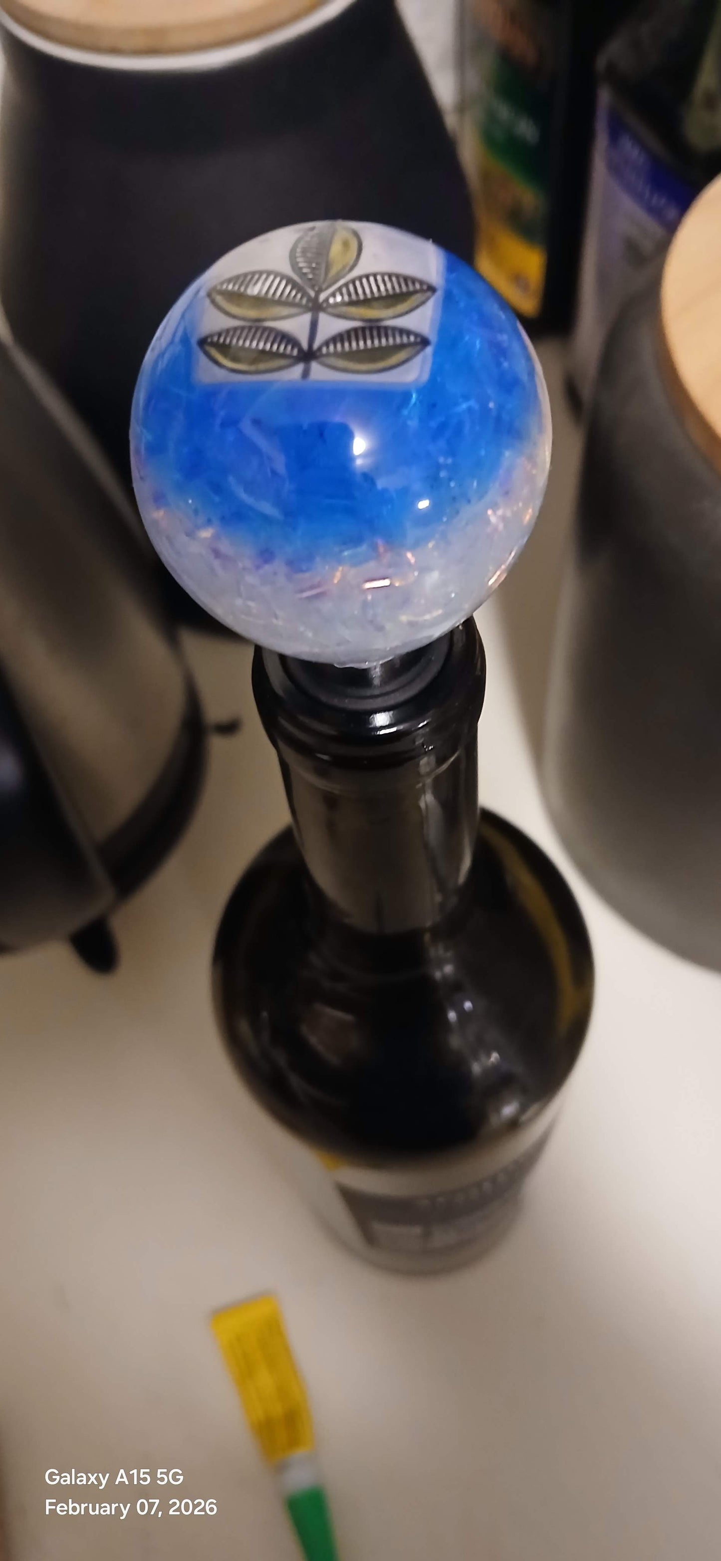 Close-up of a wine bottle with a decorative stopper on a blurred background