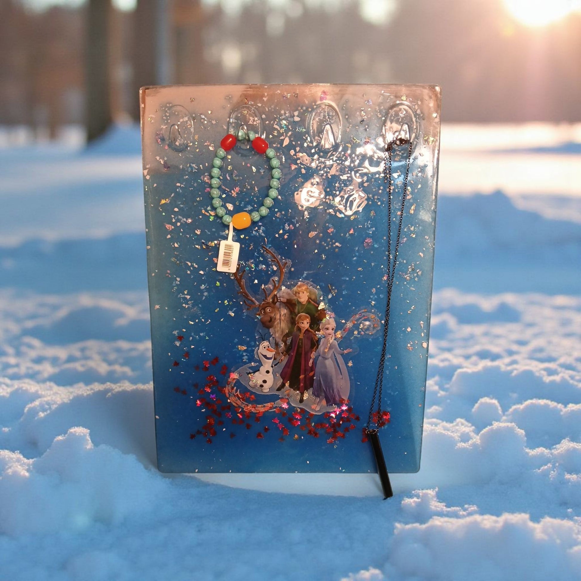 Decorative card with characters and a necklace on a snowy background