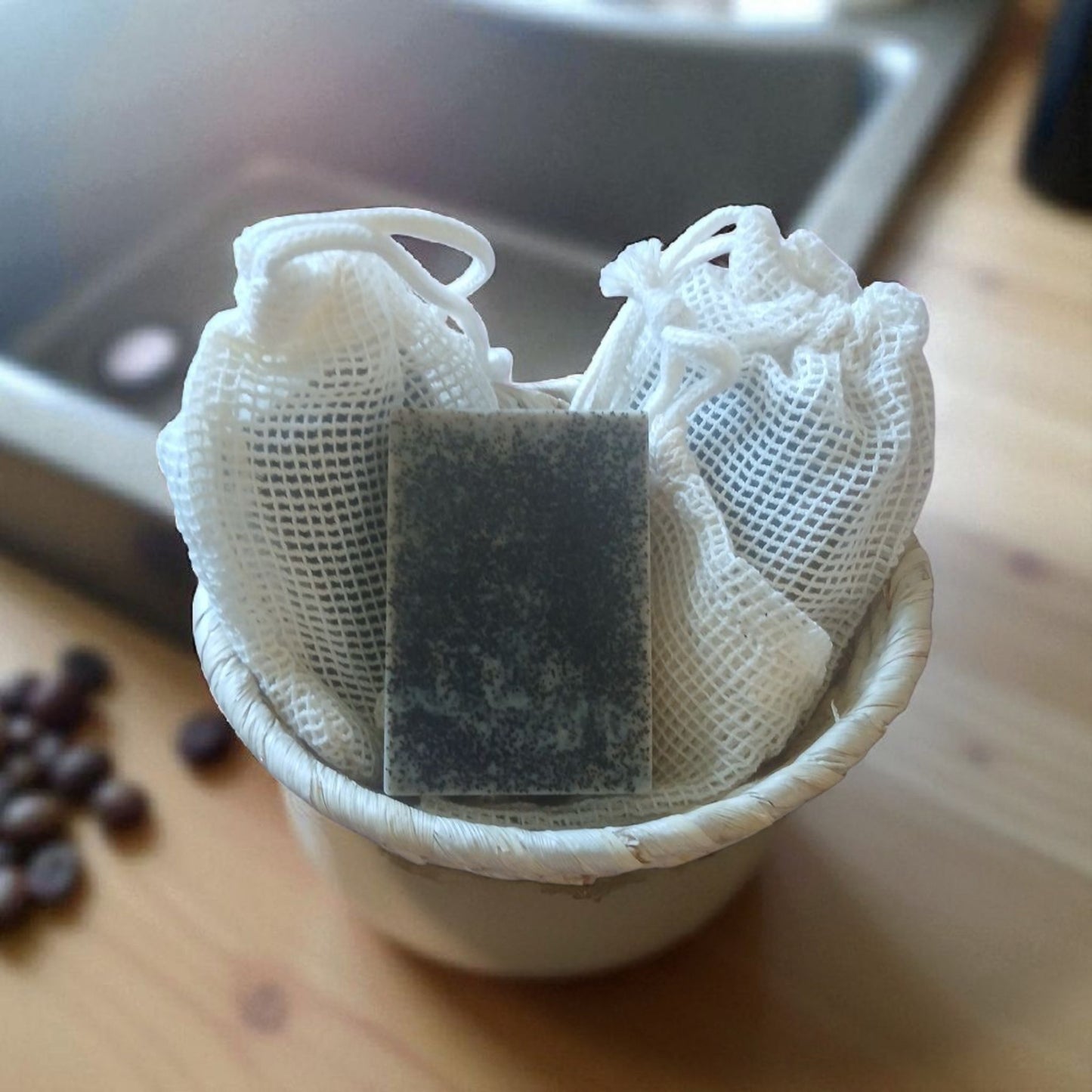 Tea bag in a mesh pouch on a wooden surface with a blurred background