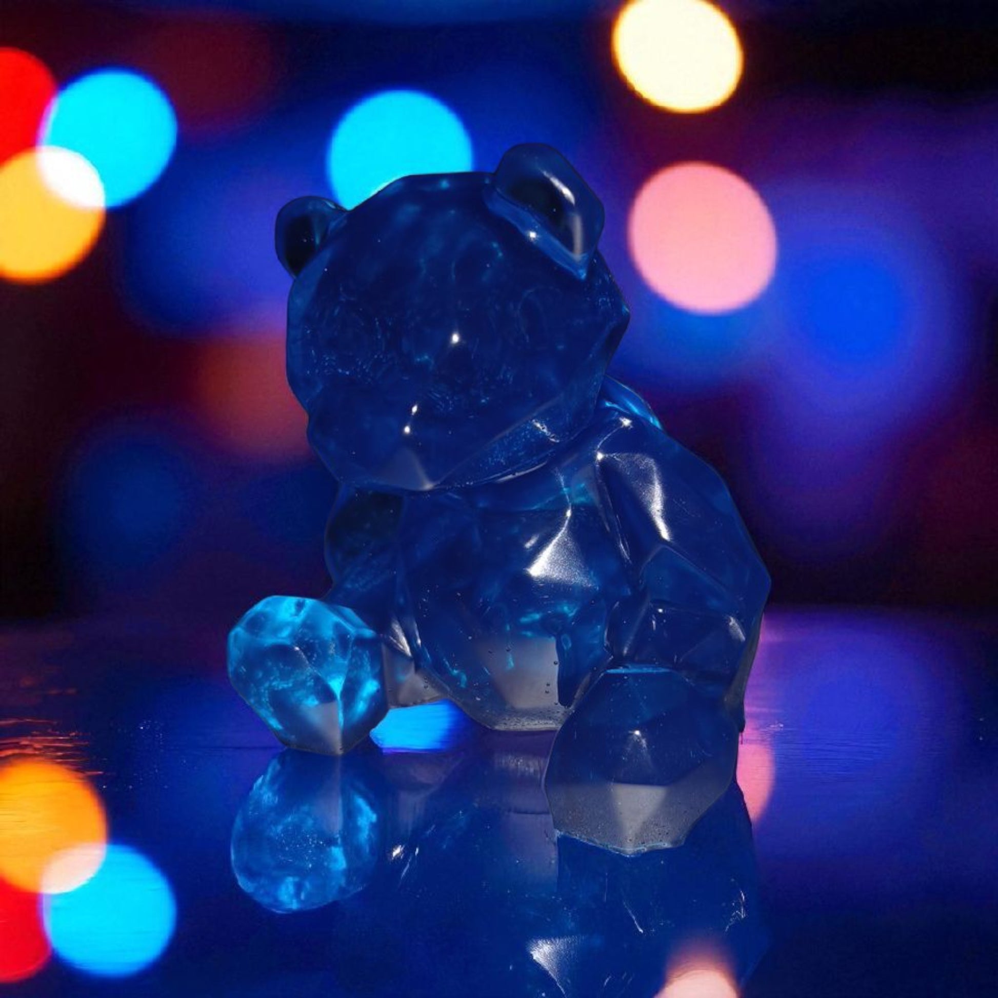 Blue gummy bear toy with colorful blurred lights in the background
